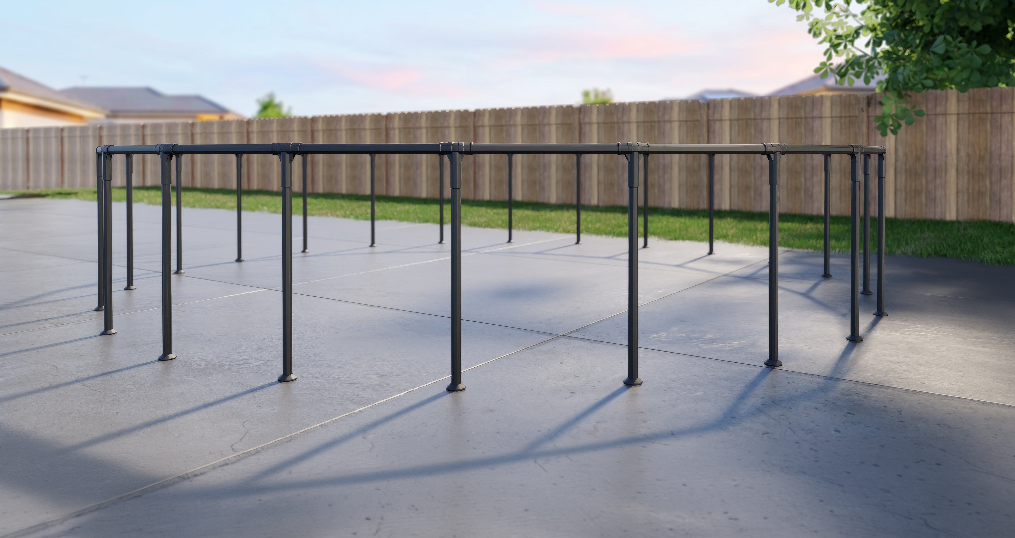 An assembled Bestway pool frame sitting on the patio in someone's backyard with a fence in the background.